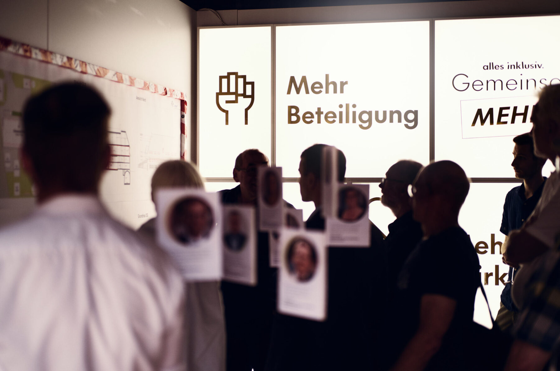 Besucherinnen und Besucher im Showroom der Fundraising-Kampagne „Gemeinsam MEHR.“ beim Open House im Hofgut Himmelreich.
